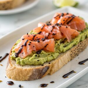 Sourdough toast with avocado, salmon, and truffle oil. Avocado Toast in French